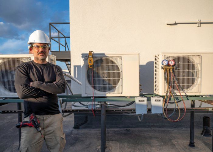 NADCA-certified Huntsville air duct cleaning technician standing by HVAC units